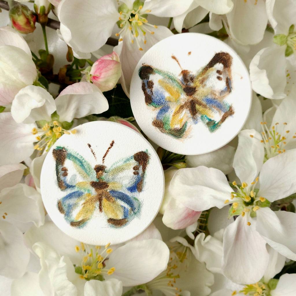 Two white lightweight earrings with oil painted colorful nature elements - butterflies. 