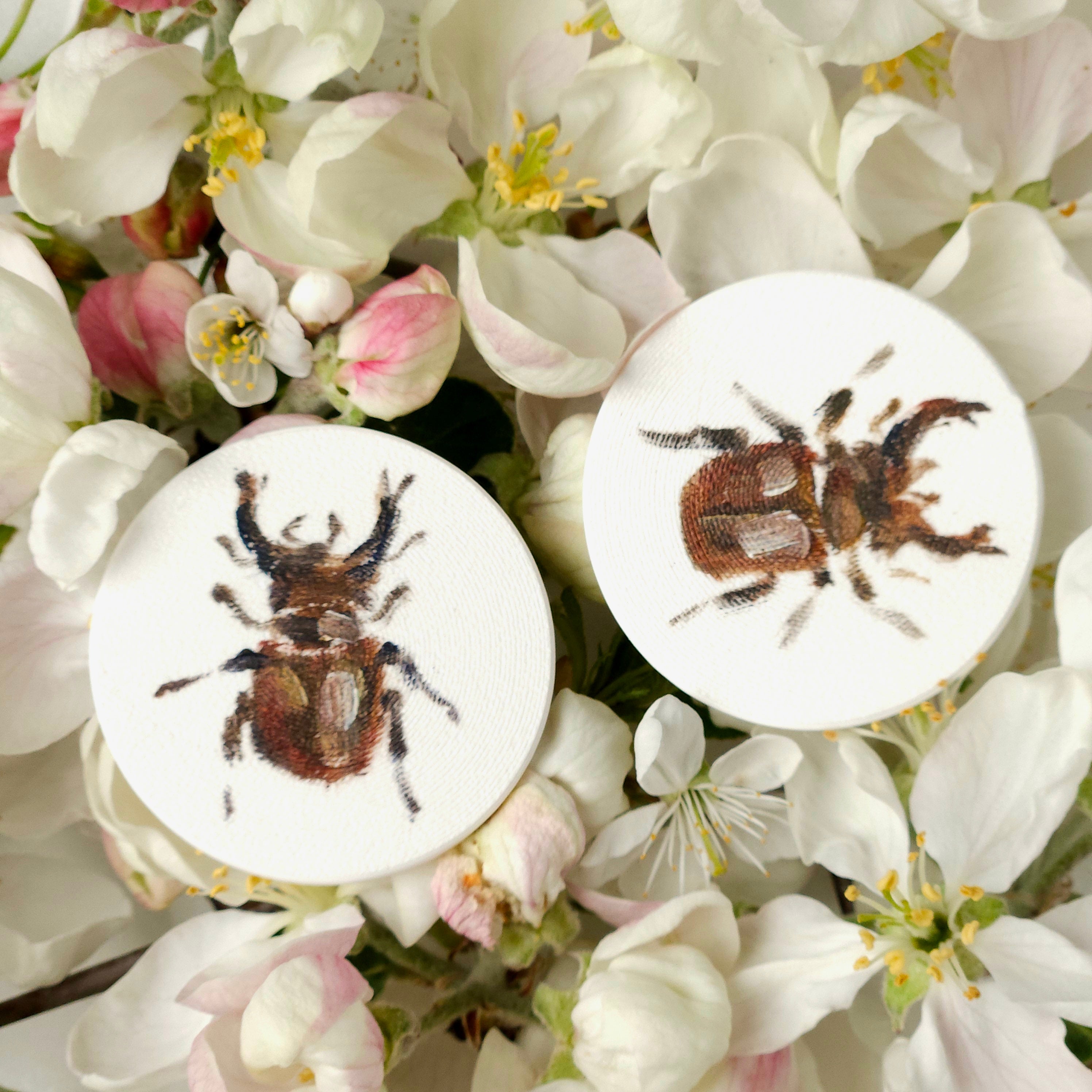 Two white lightweight earrings with oil painted colorful nature elements - flowers, bugs, butterflies. 
