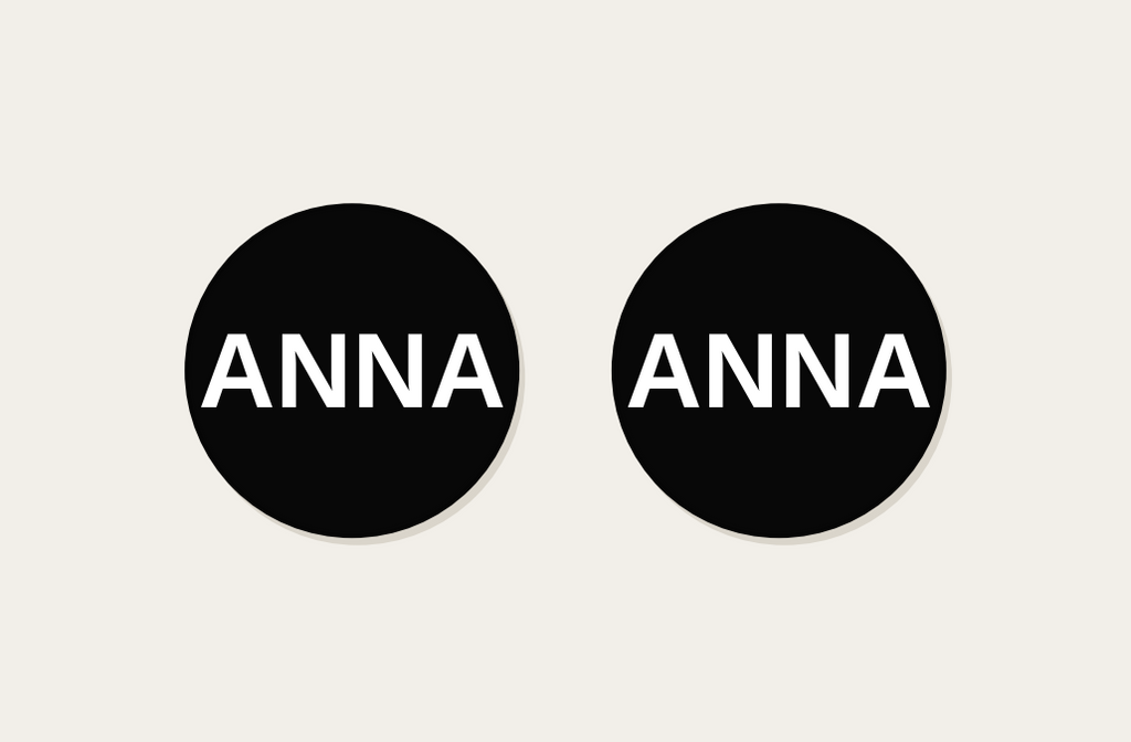 Pair of 42mm black custom text earrings reading ANNA in white Classic lettering
