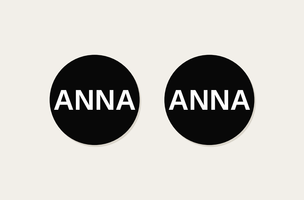 Pair of 42mm black custom text earrings reading ANNA in white Classic lettering
