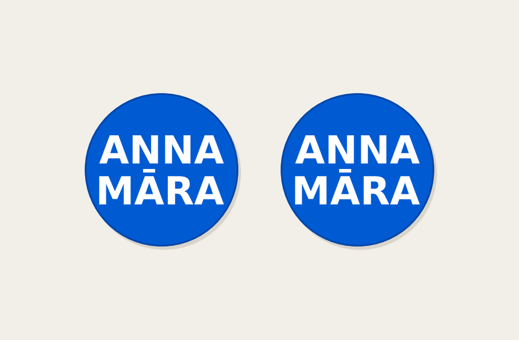 Pair of 42mm blue custom text earrings with two lines of white Modern lettering